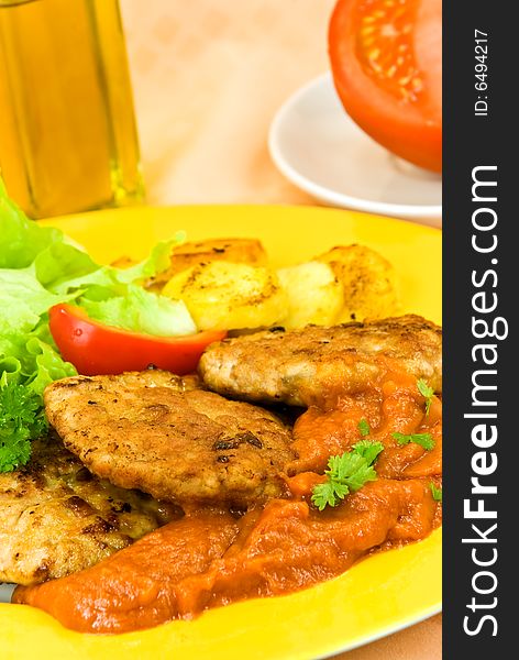 Baked hamburger with tomato sauce,fried potatoes ,salad.