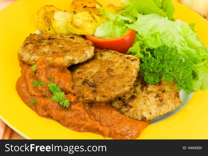 Baked hamburger with tomato sauce,fried potatoes ,salad.