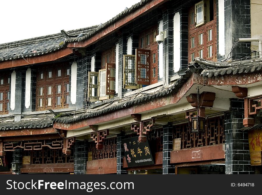 China, Yunnan province, old wooden houses in traditional style - old town in Lijiang city. China, Yunnan province, old wooden houses in traditional style - old town in Lijiang city.