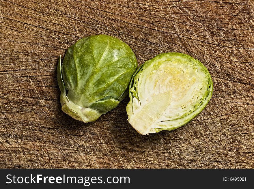 Brussels sprouts, close up, on wooden table,  studio shot. Brussels sprouts, close up, on wooden table,  studio shot.