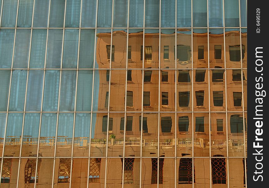 An old building reflected in a new one. An old building reflected in a new one