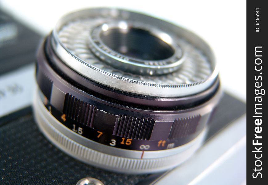 Close up of antique camera lens with white background