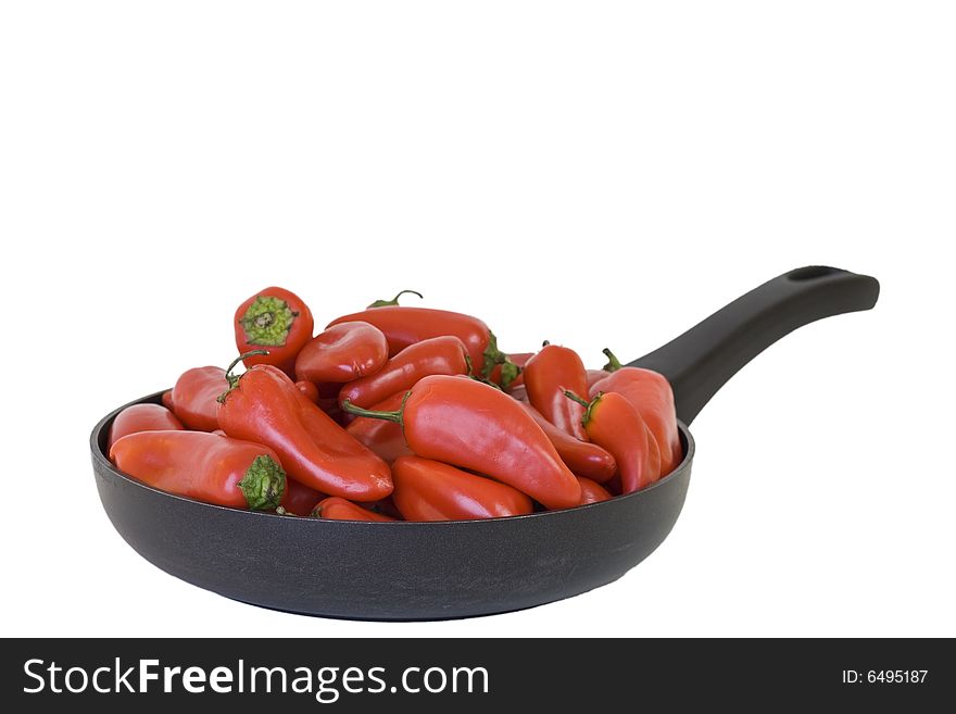 Frying pan filled with baby red bell peppers, on white background, clipping path. Frying pan filled with baby red bell peppers, on white background, clipping path.