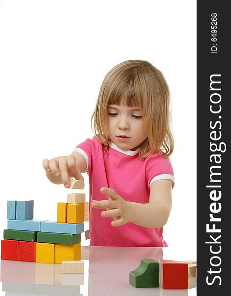 Little girl playing with cubes
