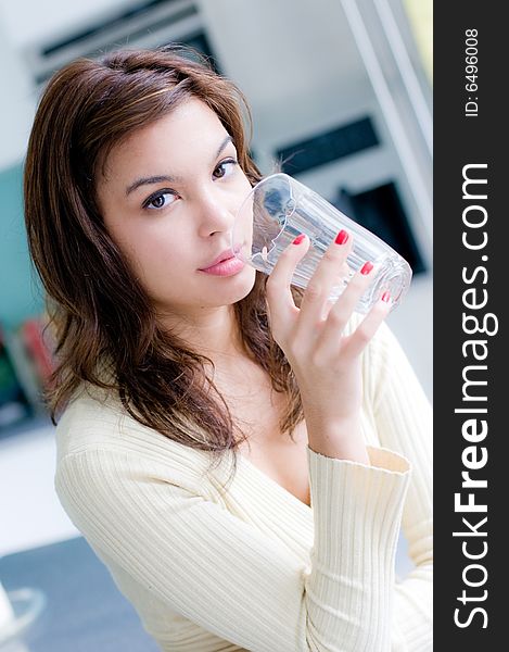 An attractive young woman at home in her kitchen. An attractive young woman at home in her kitchen