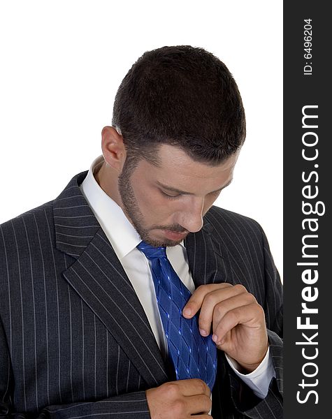 Man looking his tie on an isolated white  background