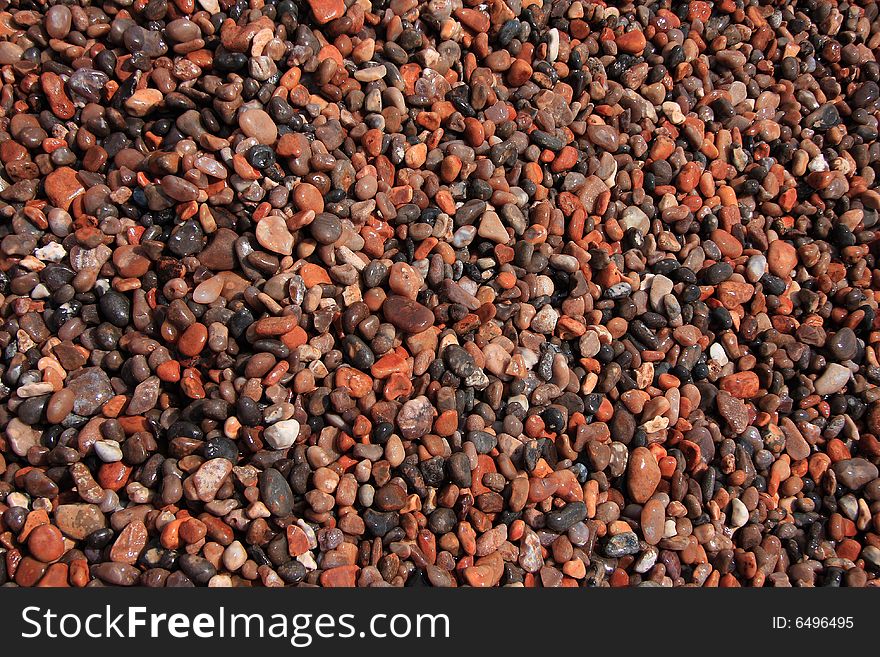 Wet beach pebbles photographed in close crop. Wet beach pebbles photographed in close crop