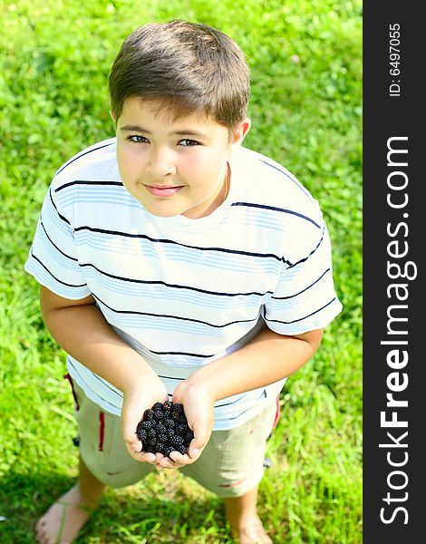 Child with a blackberry in hands