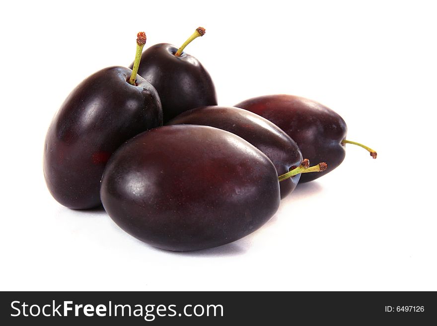 Several plums isolated on white background