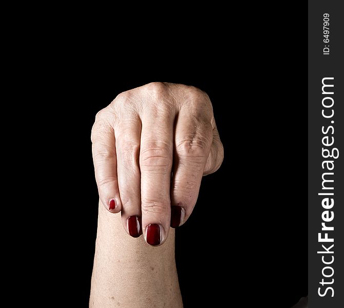 Older hand with painted nails on black background