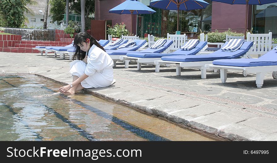 The woman relaxing at hotel pool. The woman relaxing at hotel pool