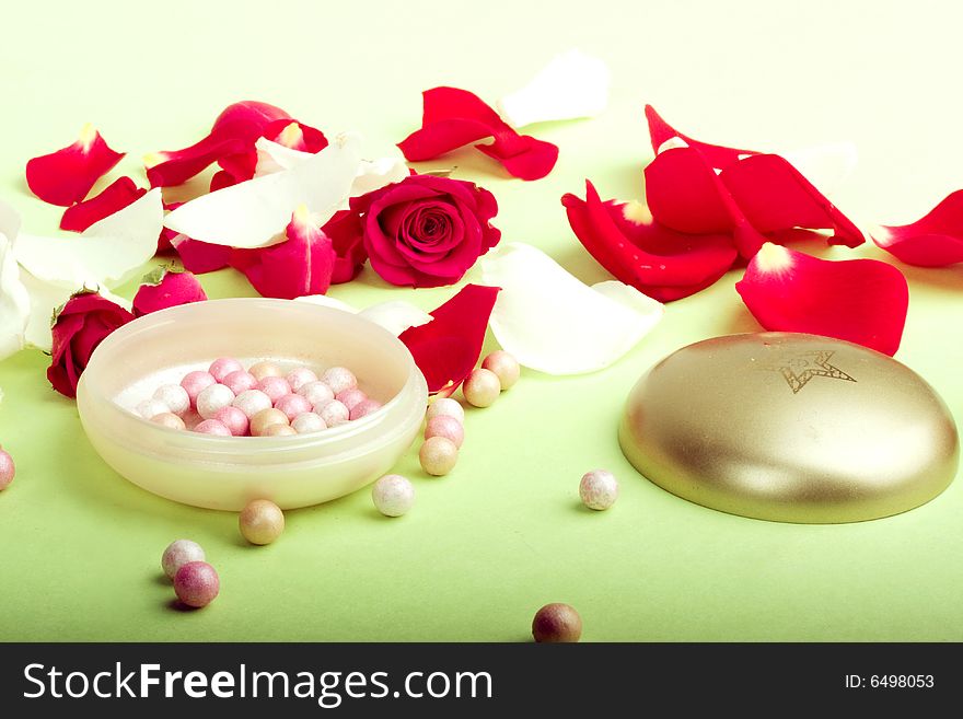 Red and white rose petals and heads with pouder isolated on light background. Red and white rose petals and heads with pouder isolated on light background