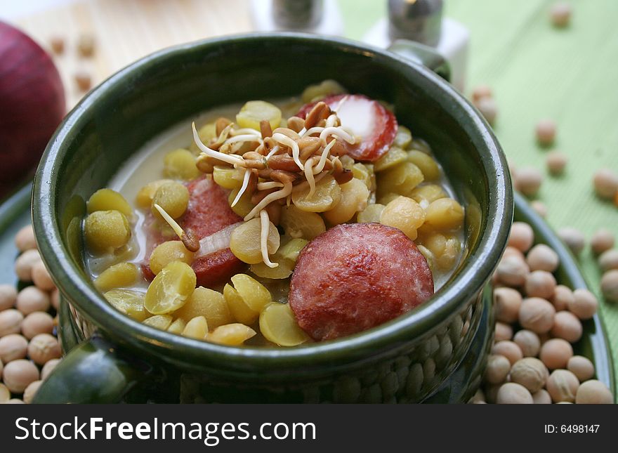 A fresh soup of peas with sausages