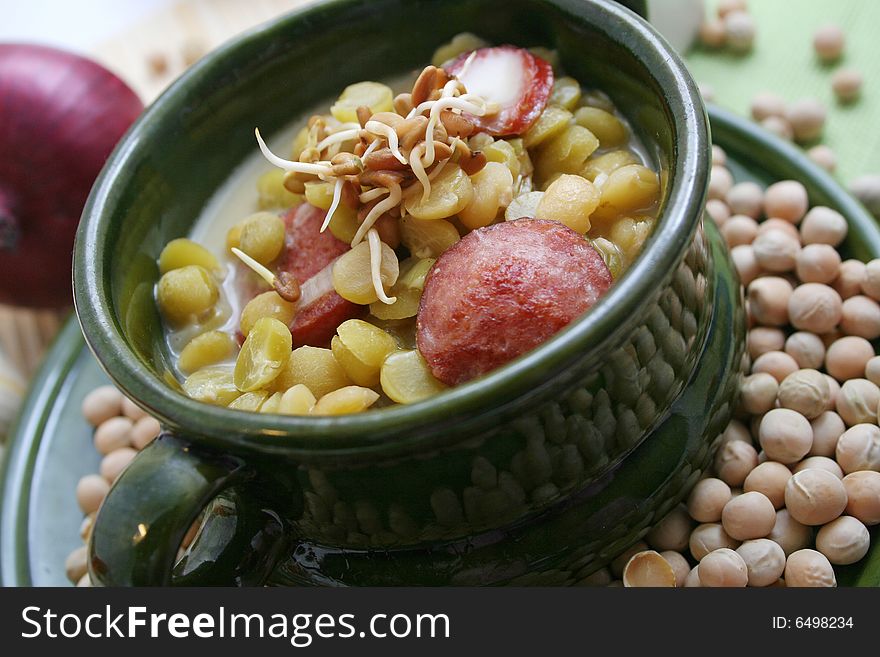 A fresh soup of peas with sausages