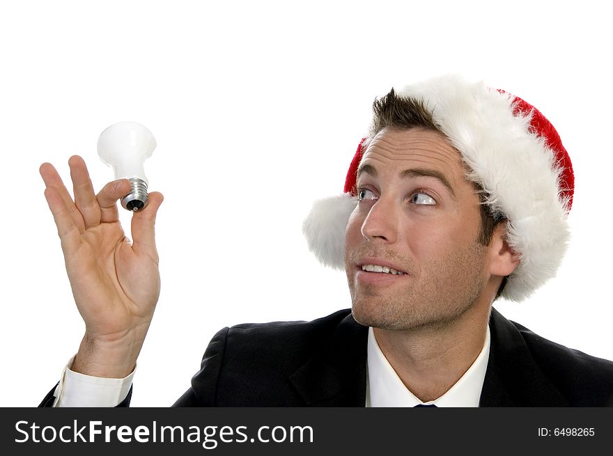 Businessman holding bulb and wearing santacap  on an isolated white background