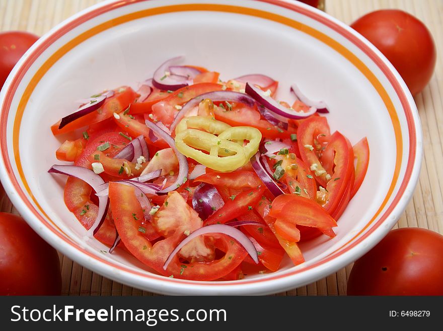 A fresh salad of tomatoes with red onions