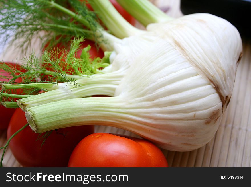 A fresh fennel and some red tomatoes