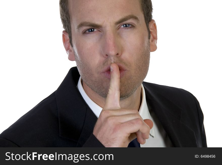 Portrait of businessman with his finger on his lips on white background