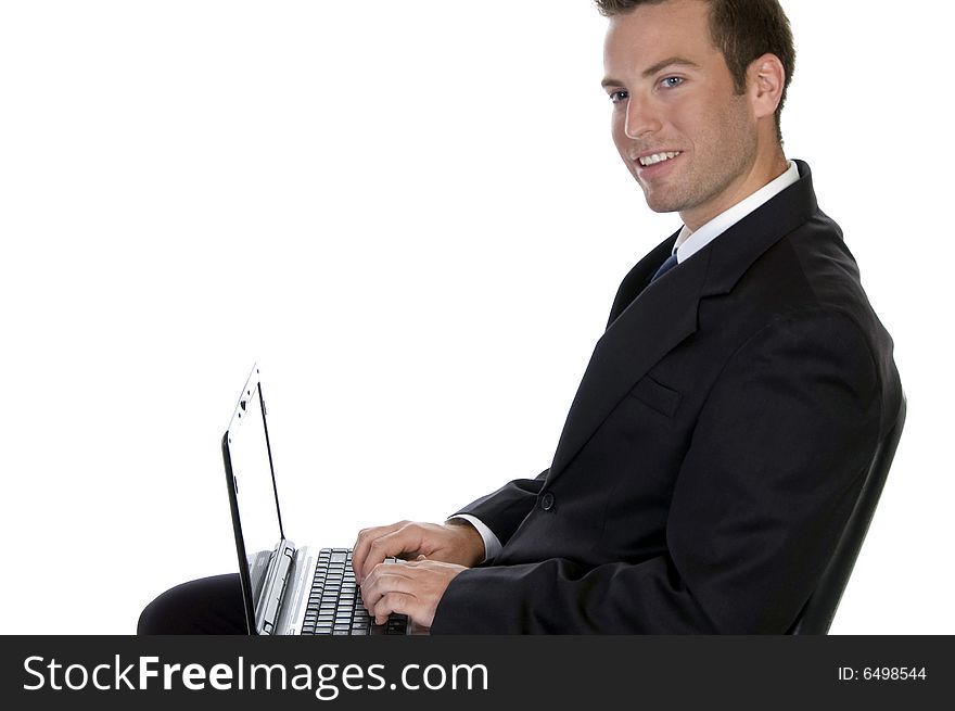 Successful businessman with laptop against white background