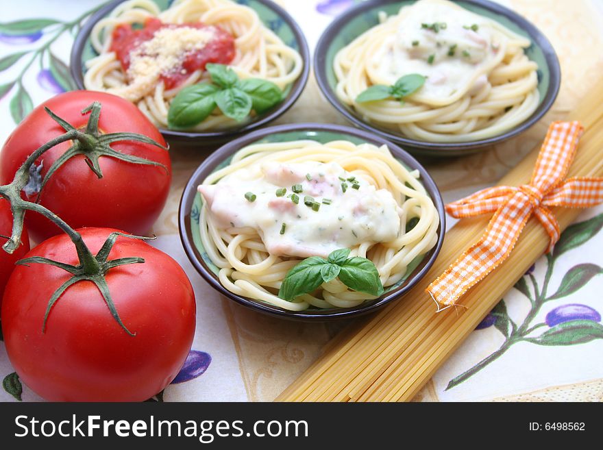 Italian pasta with cheese-sauce and tomato-sauce with basil