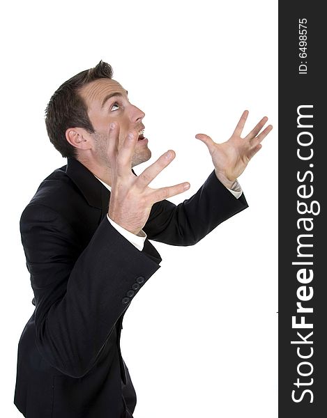 Young businessman yelling with raised arms on white background