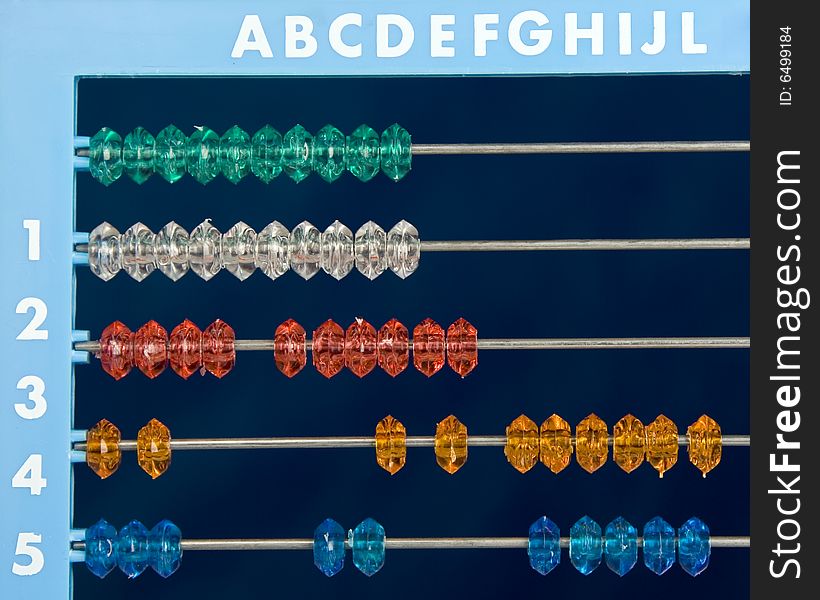 Colored abacus over dark blue background