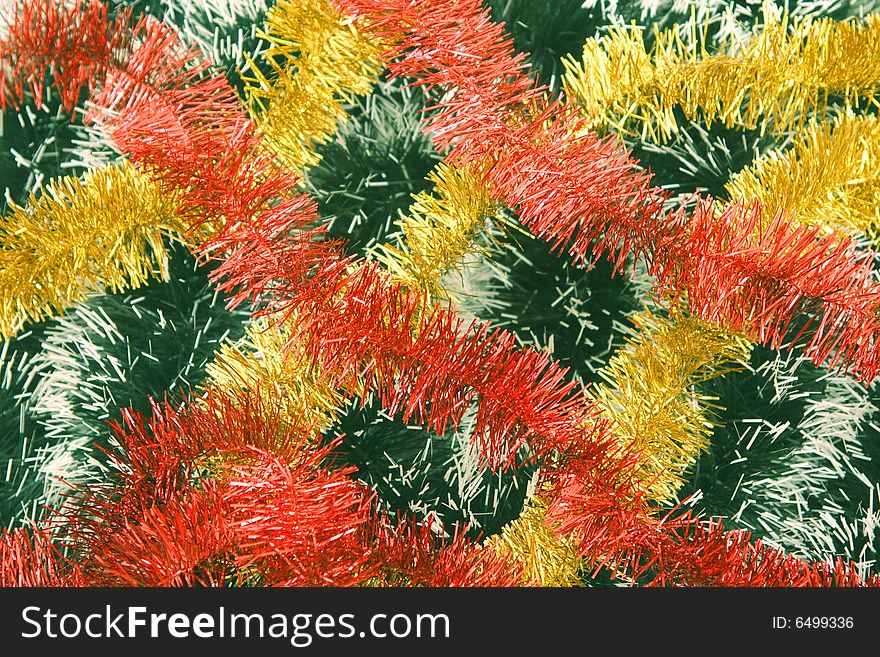 Background from a tinsel of red, yellow and green color.