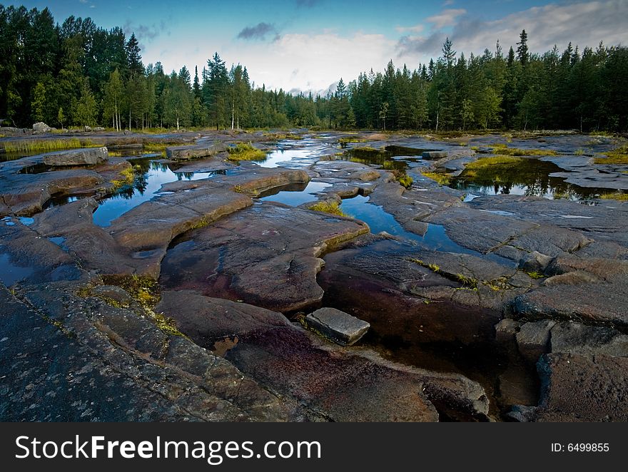 A view of the place where wild rocky surface spotted with water. A view of the place where wild rocky surface spotted with water