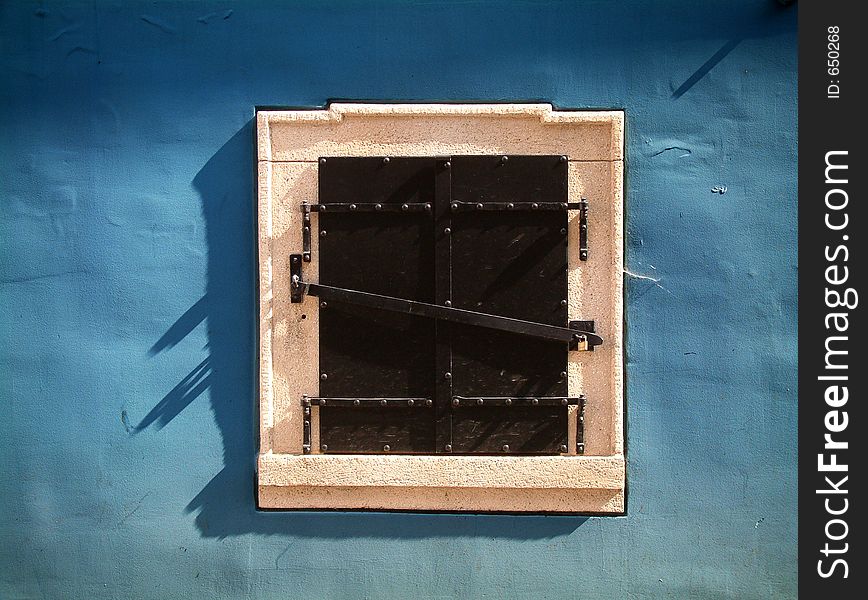 Stone white window on the blue wall. Stone white window on the blue wall.