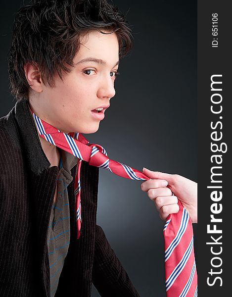 Young man on dark Background with red tie. Young man on dark Background with red tie