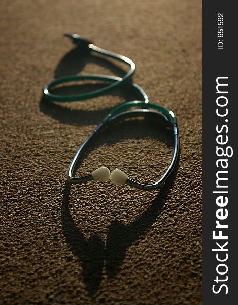 An image of a stethoscope and shadow, an essential tool for a doctor or nurse or anyone in the medical profession.