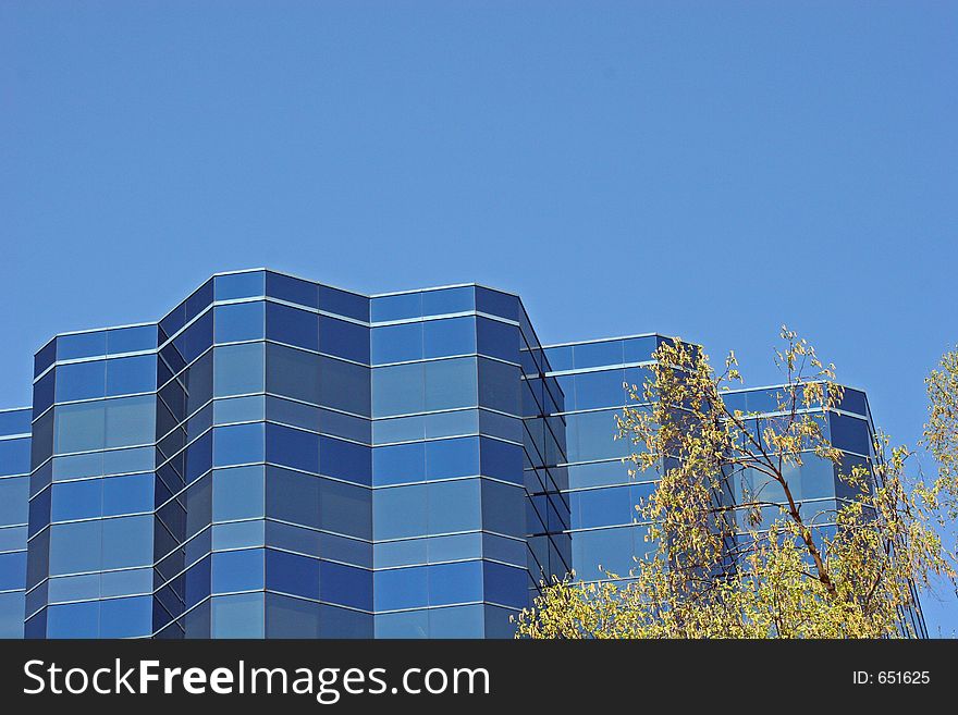 Blue glass office tower against blue sky. Blue glass office tower against blue sky