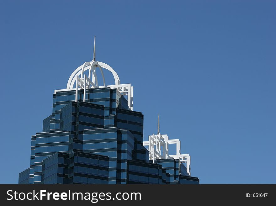 Twin office towers against blue sky. Twin office towers against blue sky