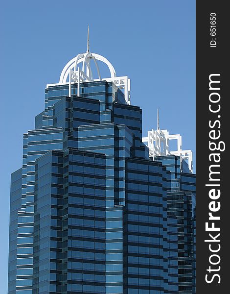 Twin office towers against blue sky. Twin office towers against blue sky