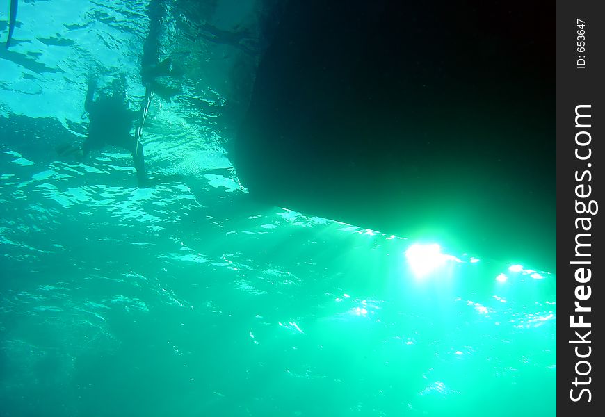 A diver retuns to their dive boat. A diver retuns to their dive boat