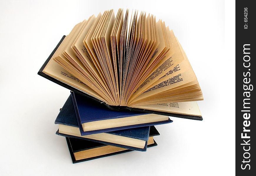 Four old books on white background