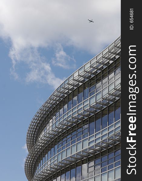 Modern Building detail with Jet Airplane in the sky. Modern Building detail with Jet Airplane in the sky