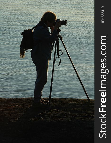 Silhouette of photograper with tripod. Silhouette of photograper with tripod