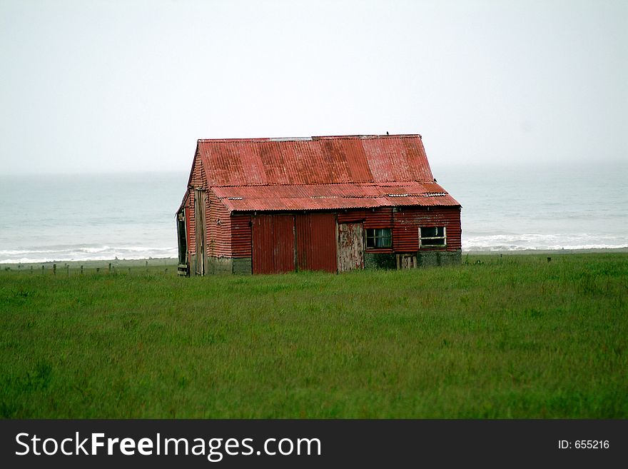 Red barn on coast line of southern New Zealand. Red barn on coast line of southern New Zealand