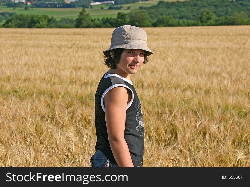 Young boy in a Barley field smiling