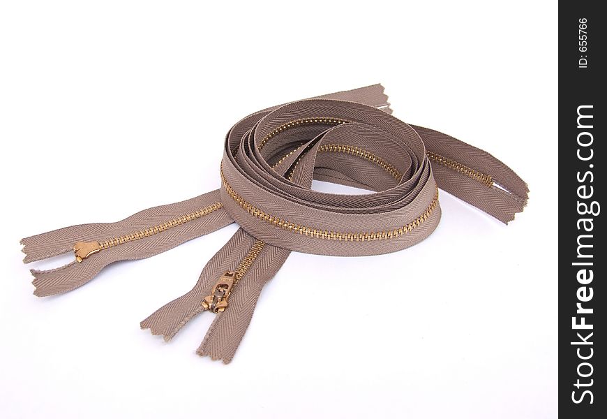 A close up shot of 3 brown long zippers. A close up shot of 3 brown long zippers