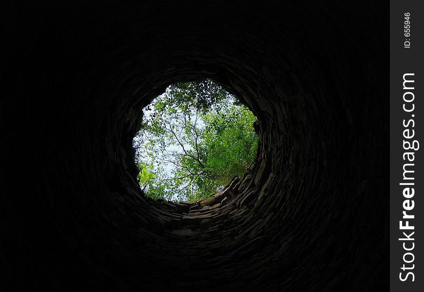 Skyward outlook through an old chimney of an 19th century ironworks factory. Skyward outlook through an old chimney of an 19th century ironworks factory.