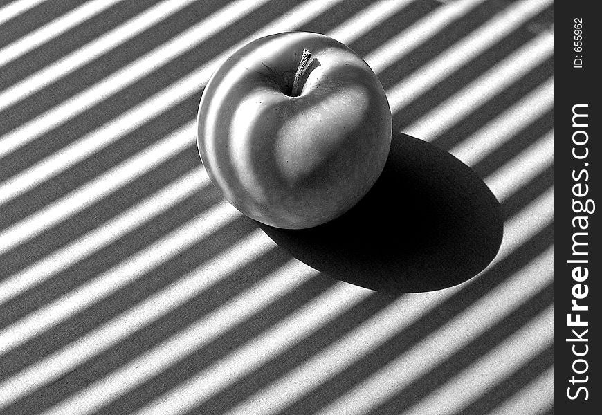 Apple in striped sunlight. Apple in striped sunlight