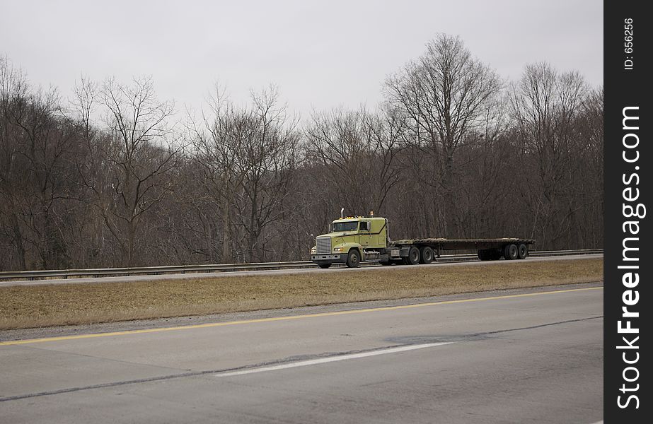 Flatbed Semi Truck on the Highway with Copy Space