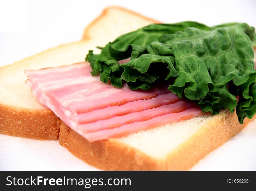 (Isolated) sandwich with bacon and salad. (Isolated) sandwich with bacon and salad