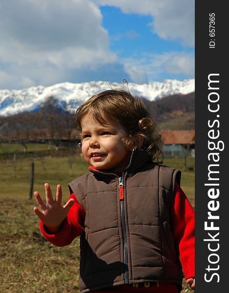 Portrait of a young girl, against mountain scenery. Portrait of a young girl, against mountain scenery.