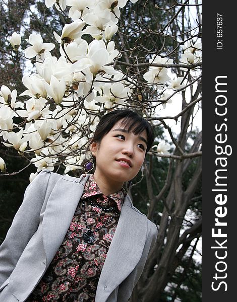 Korean woman standing under blossoming tree in spring. Korean woman standing under blossoming tree in spring