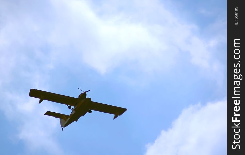 Flying hydroplane on blue sky background. Flying hydroplane on blue sky background