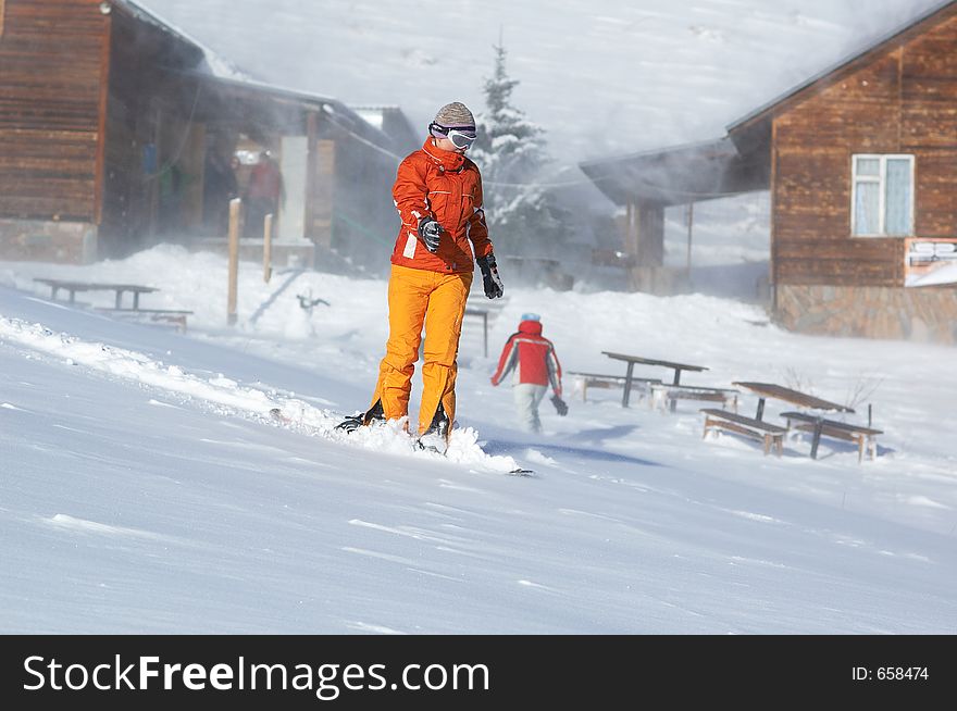 Snowboard girl downhill in snowstorm. Snowboard girl downhill in snowstorm