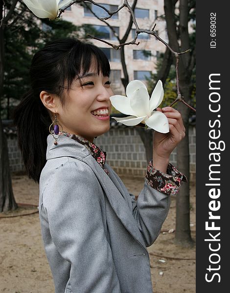 Pretty Korean woman holding a white flower